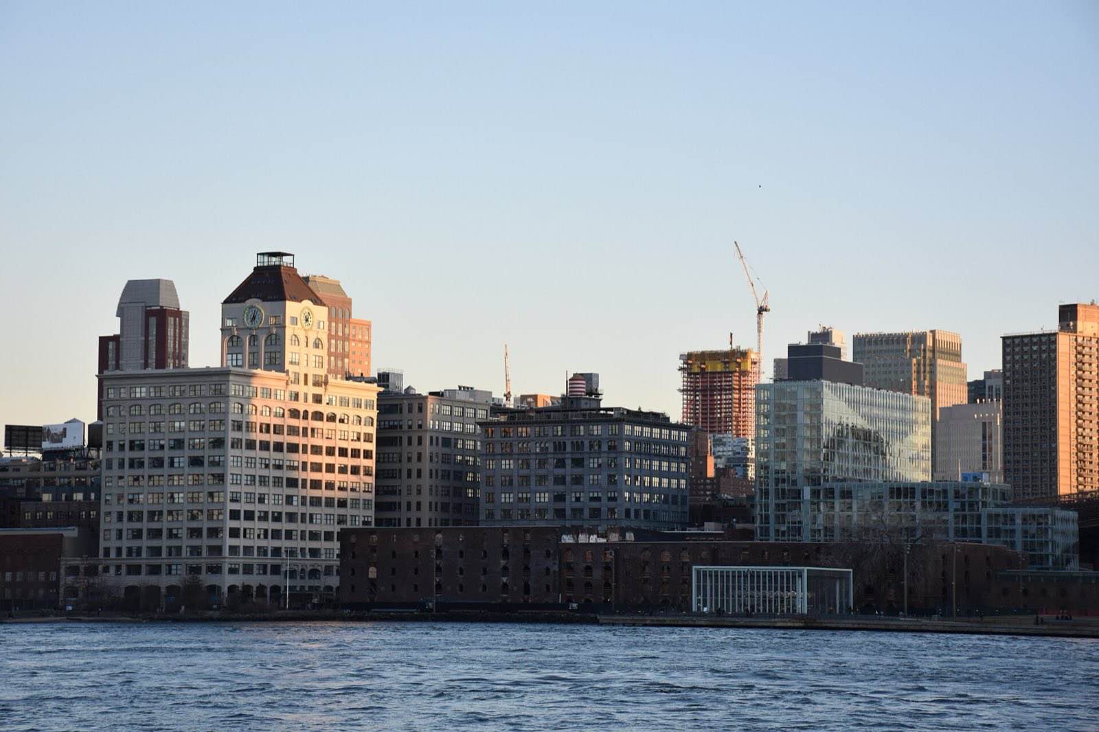 The neighborhood of Dumbo, Brooklyn at sunset, as seen from the Manhattan shore.