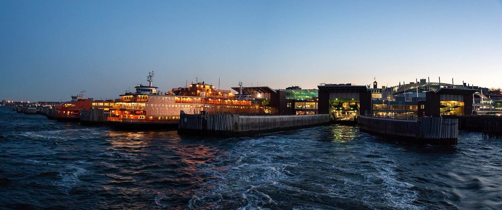 Panorama of Staten Island Ferry Terminal, departing from St. George at sunset. Photo by Eric Kilby https://www.flickr.co